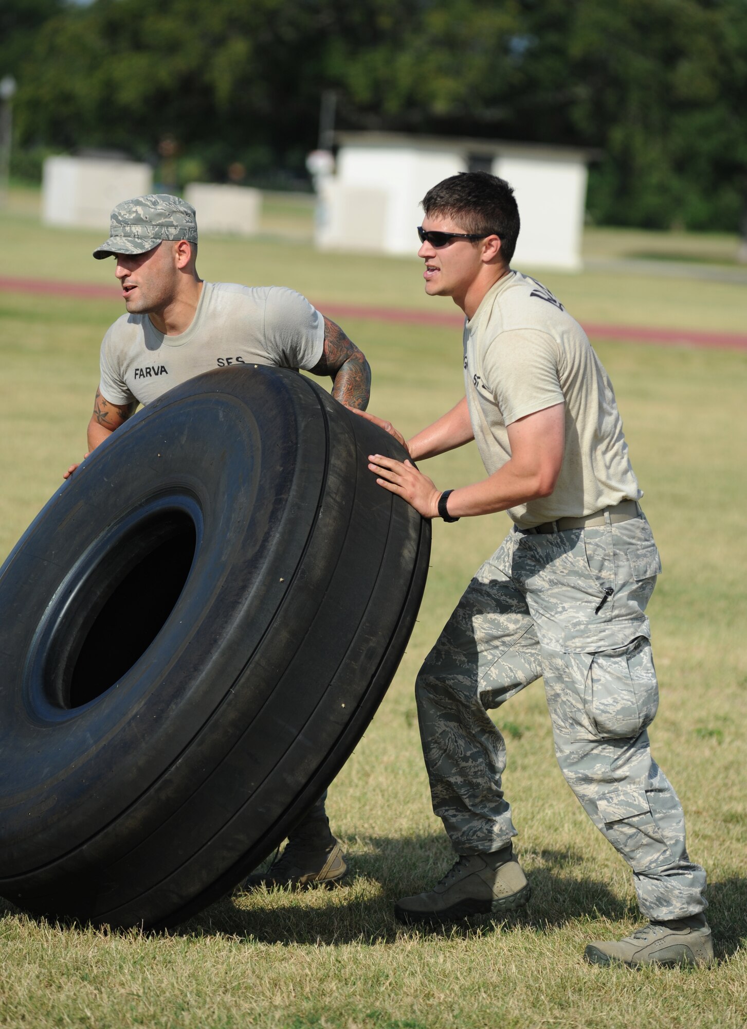 Ram Rod team members from the 81st Security Forces Squadron, Staff Sgt. Christopher Hernandez and Capt. Chris Porta, compete in the “Tire Toss” challenge during the 81st Mission Support Group Ultimate Warrior Challenge June 1, 2012, at the Triangle Track at Keesler Air Force Base, Miss.  The challenge consists of two personnel flipping an aircraft tire to the designated location then the awaiting team members flipped it back to the start.  The challenge was held in honor of fellow service members who lost their lives in the fight for our nation’s freedom. It consisted of nine four-member teams racing in a competition designed to take them through various aspects of a deployment.  The Ram Rods were the first place winners of the Ultimate Warrior Challenge.  (U.S. Air Force photo by Kemberly Groue)