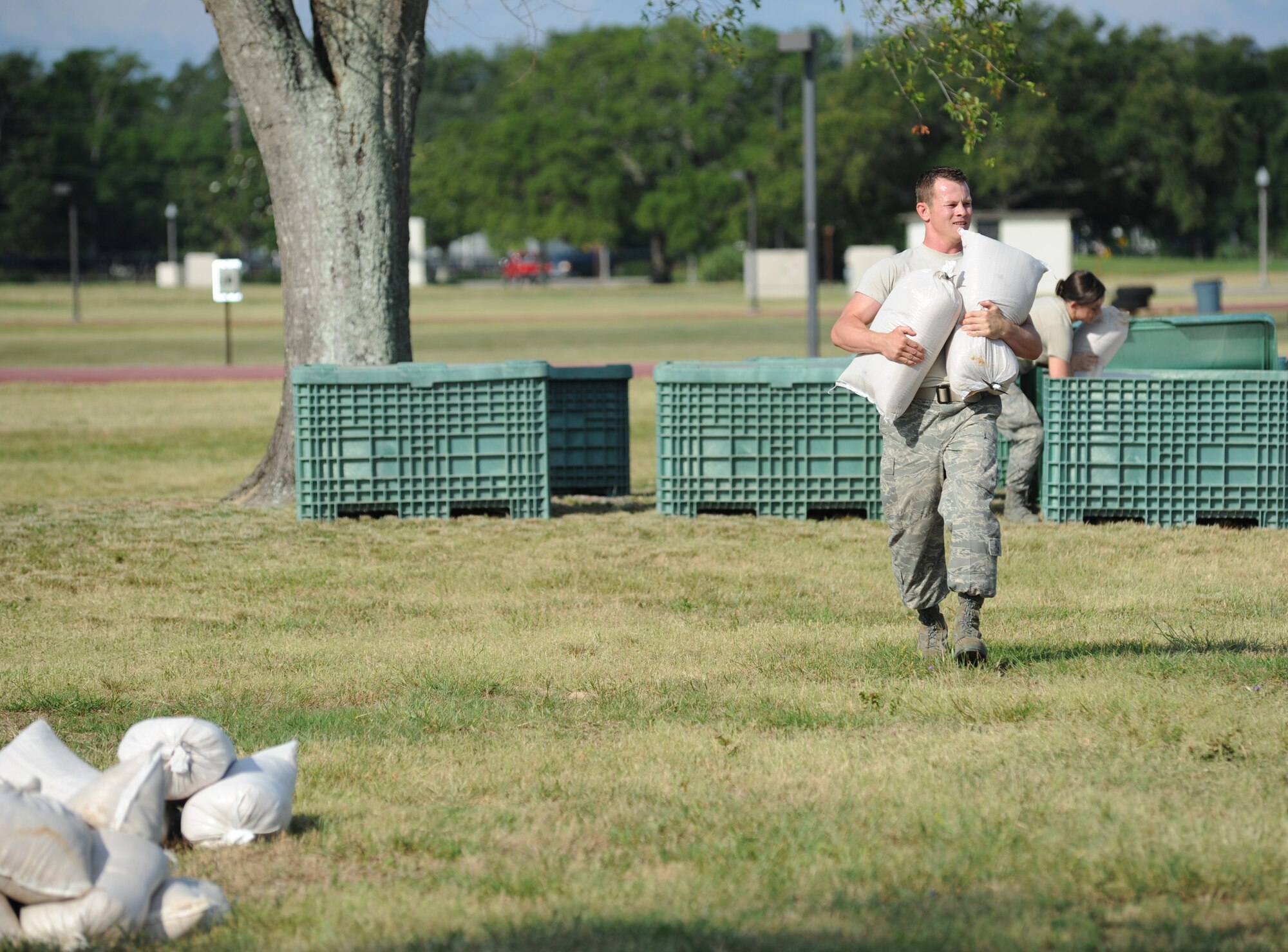 Staff Sgt. Blaine Hunter, a Log Monsters team member from the 81st Logistics Readiness Squadron competes in the “Bunker Hill” challenge in which each team must properly build a freestanding sandbag barricade per the Airman’s Manual specifications during the 81st Mission Support Group Ultimate Warrior Challenge June 1, 2012, at the Triangle Track at Keesler Air Force Base, Miss.  The challenge was held in honor of fellow service members who lost their lives in the fight for our nation’s freedom. It consisted of nine four-member teams racing in a competition designed to take them through various aspects of a deployment.  (U.S. Air Force photo by Kemberly Groue)