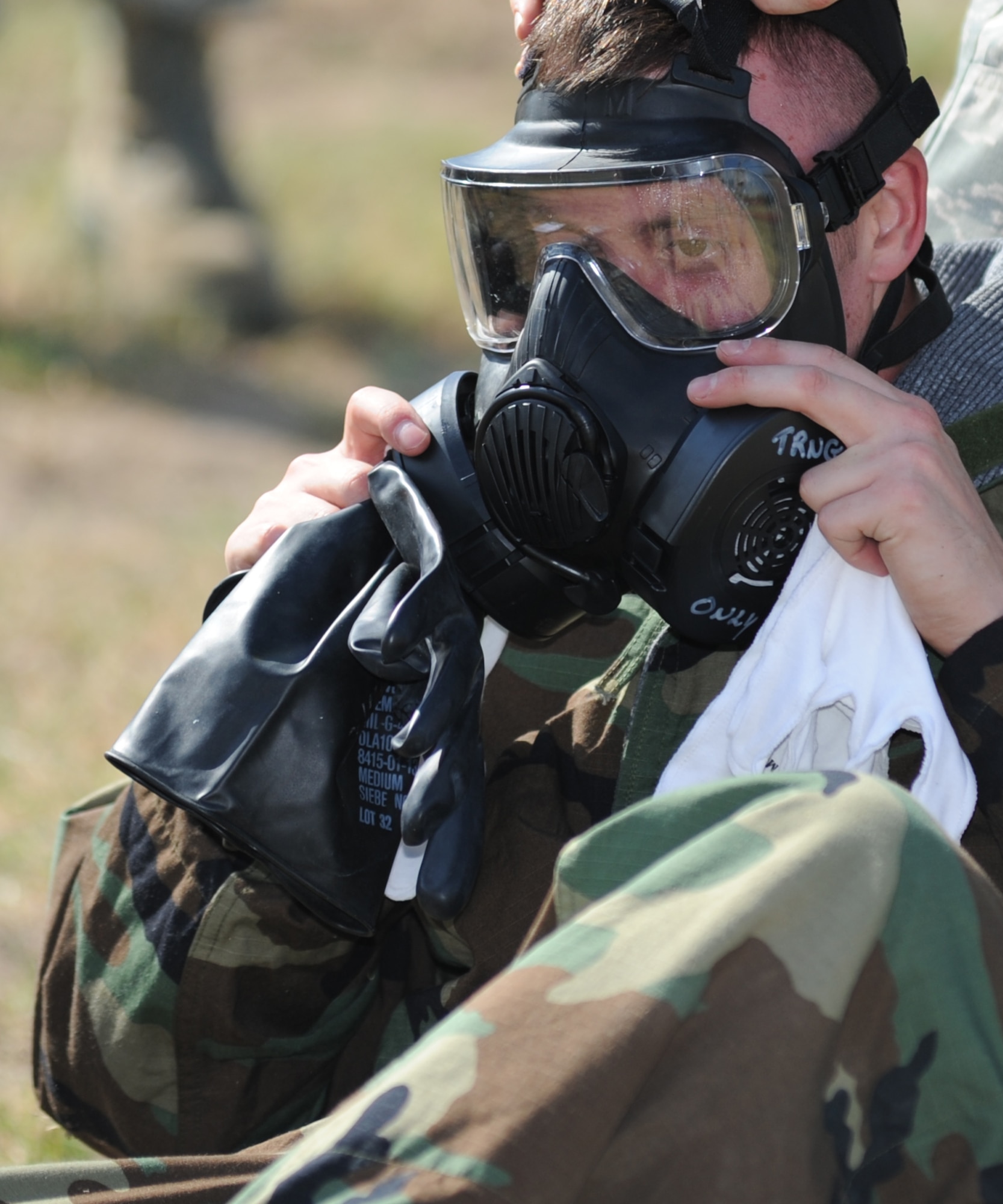 Staff Sgt. David Cannon, 81st Force Support Squadron and team member of Shock and Awe, checks the air way of his gas mask during the “MOPP Gear” challenge in which the team members must accurately reach MOPP level 4 as fast as possible before continuing on to the next challenge during the 81st Mission Support Group Ultimate Warrior Challenge June 1, 2012, at the Triangle Track at Keesler Air Force Base, Miss.  The challenge was held in honor of fellow service members who lost their lives in the fight for our nation’s freedom. It consisted of nine four-member teams racing in a competition designed to take them through various aspects of a deployment.  (U.S. Air Force photo by Kemberly Groue)