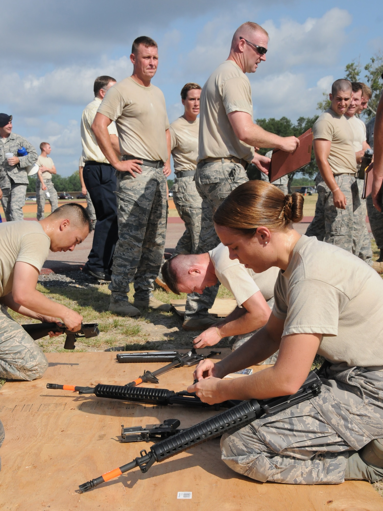 Airman 1st Class Erika Fields, 81st Force Support Squadron and member of Team Blazers, works to disassemble a M4 weapon in the “combat arms weapons challenge” during the 81st Mission Support Group Ultimate Warrior Challenge June 1, 2012, at the Triangle Track at Keesler Air Force Base, Miss.  The team members also have to reassemble the weapon once completed with the disassembly has been done.  The challenge was held in honor of fellow service members who lost their lives in the fight for our nation’s freedom. It consisted of nine four-member teams racing in a competition designed to take them through various aspects of a deployment.  (U.S. Air Force photo by Kemberly Groue)