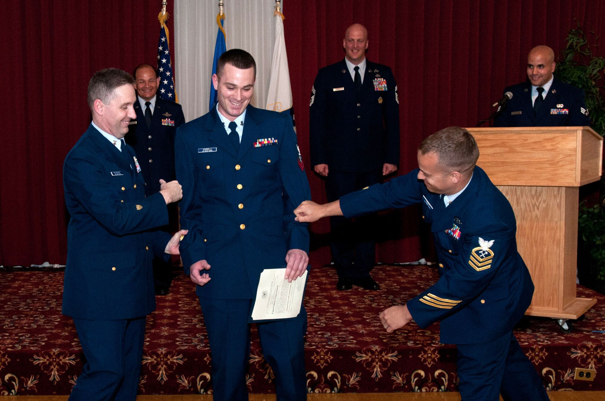 HANSCOM AIR FORCE BASE, Mass. - Newly promoted Petty Officer 2nd Class Nicholas L. Borrelli, U.S. Coast Guard, gets his rank pinned on by Command Master Chief David Rochefort (left) and Chief Petty Officer Aaron Comeau during the Enlisted Promotion Ceremony May 31 at the Minuteman Commons. Borrelli is currently a student at Hanscom’s Airman Leadership School. (U.S. Air Force photo by Rick Berry)