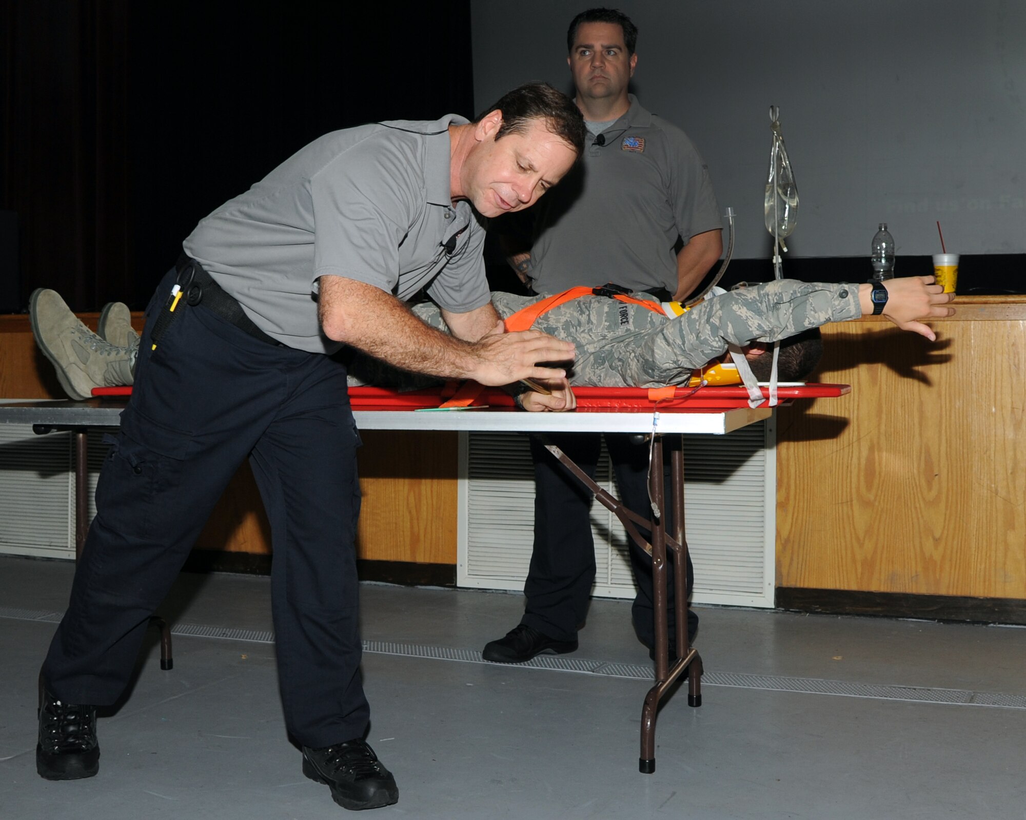 ALTUS AIR FORCE BASE, Okla. – Miami-Dade Fire Rescue Lieutenant Ralph Jimenez, co-founder of Florida Stay Alive from Education (S.A.F.E.) Inc., simulates the procedures performed on a trauma victim with Airman 1st Class Franklin Ramos, 97th Air Mobility Wing Public Affairs still photographer, during the Street Smart presentation at the Veterans Theater on base June 5, 2012. Presenters from Florida S.A.F.E. shared devastating stories and graphic pictures demonstrating the consequences of poor choices such as not wearing seatbelts, eating or texting while driving, and driving under the influence of drugs or alcohol. (U.S. Air Force Photo by Airman Klynne Pearl Serrano / 97th Air Mobility Wing Public Affairs / Released)