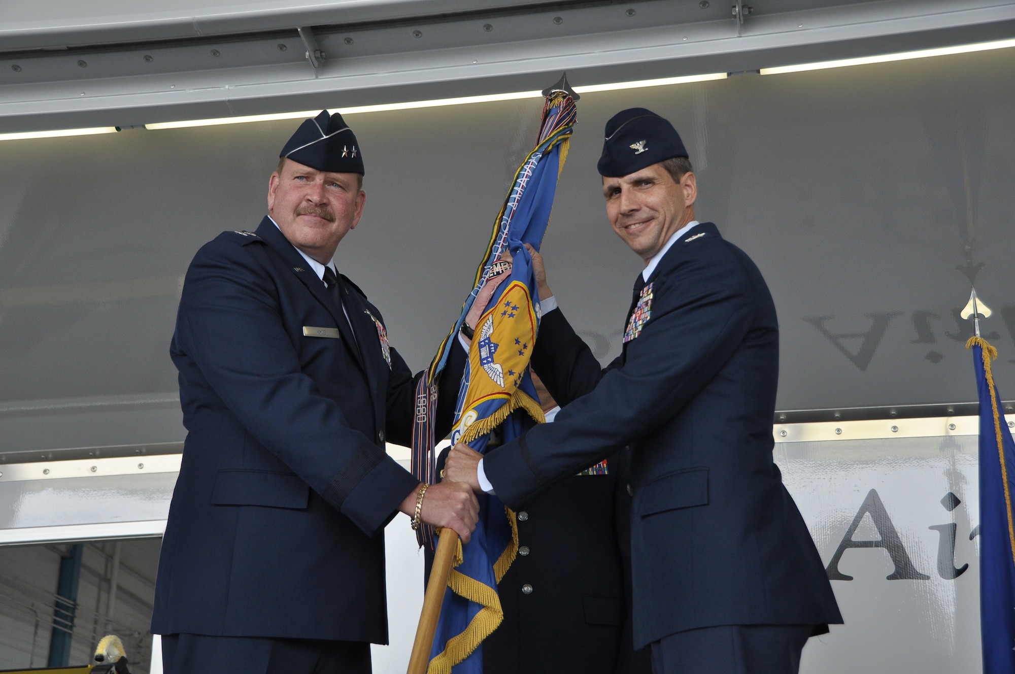 Col. Jeffrey T. Pennington, right, incoming 433rd Airlift Wing commander, accepts the Wing’s flag from Maj. Gen. Mark A. Kyle, 4th Air Force commander, Air Force Reserve Command, March Air Reserve Base, Calif, during a Change of Command ceremony June 3, at the 433rd Airlift Wing, Joint Base San Antonio - Lackland AFB, Texas. Col. Pennington took over command from outgoing commander Brig. Gen. Kenneth D. Lewis. (U.S. Air Force photo/Senior Airmen Brian McGloin)