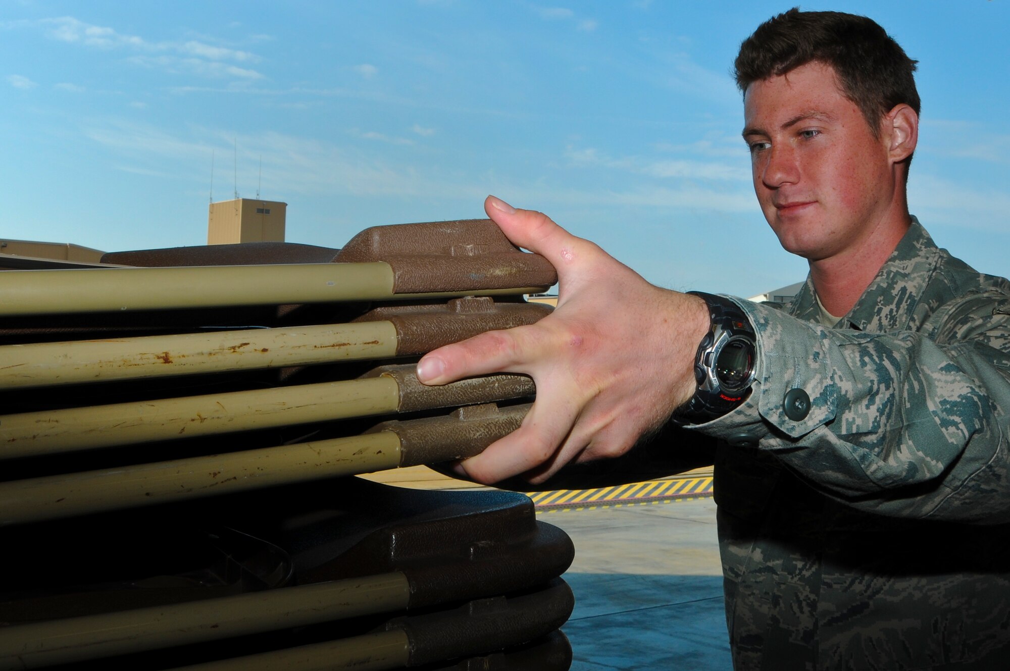 Airman Patrick Nydegger, 911th Maintenance Squadron non-destructive inspection apprentice, assists with setting up a dining area for the upcoming family day at the 911th Airlift Wing, June 2, 2012. The family day will include food games and other various events for family members of 911 AW Airmen, so they can see what the Airmen do on base and interact with the other Air Force families. (U.S. Air Force photo by Senior Airman Joshua J. Seybert/Released)