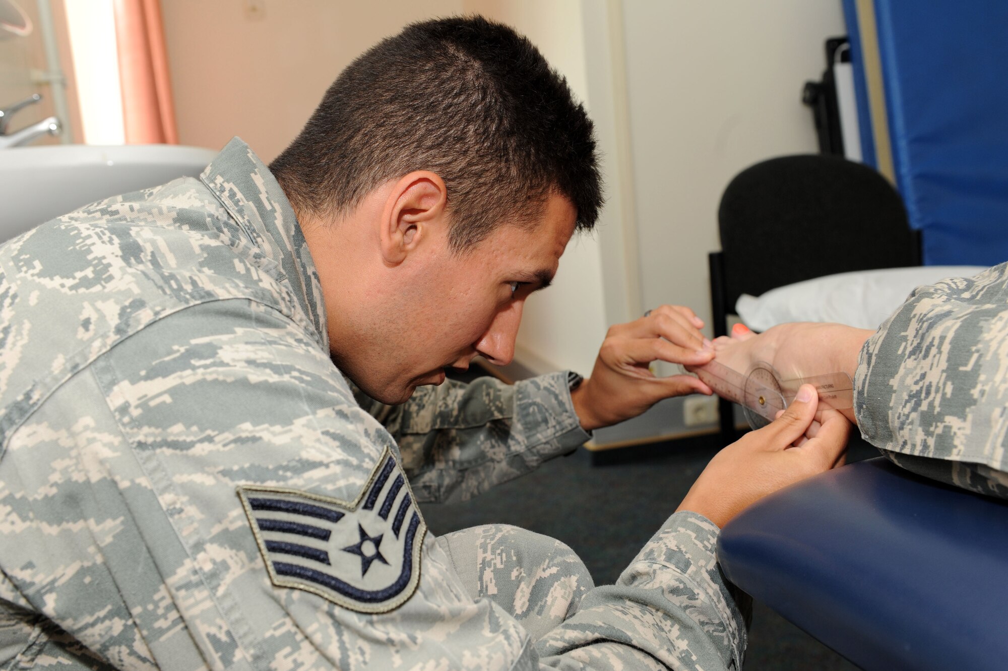SPANGDAHLEM AIR BASE, Germany – Staff Sgt. Joseph Suarez, 52nd Medical Operations Squadron physical therapy technician, uses a goniometer to check the available range of motion of the ankle of Airman 1st Class Shilah Keltner, 52nd Force Support Squadron food service journeyman, during an evaluation at the physical therapy clinic here June 5. The clinic provides service to active-duty service members as well as family members and retirees who are recovering from surgery. (U.S. Air Force photo by Senior Airman Christopher Toon/Released)


