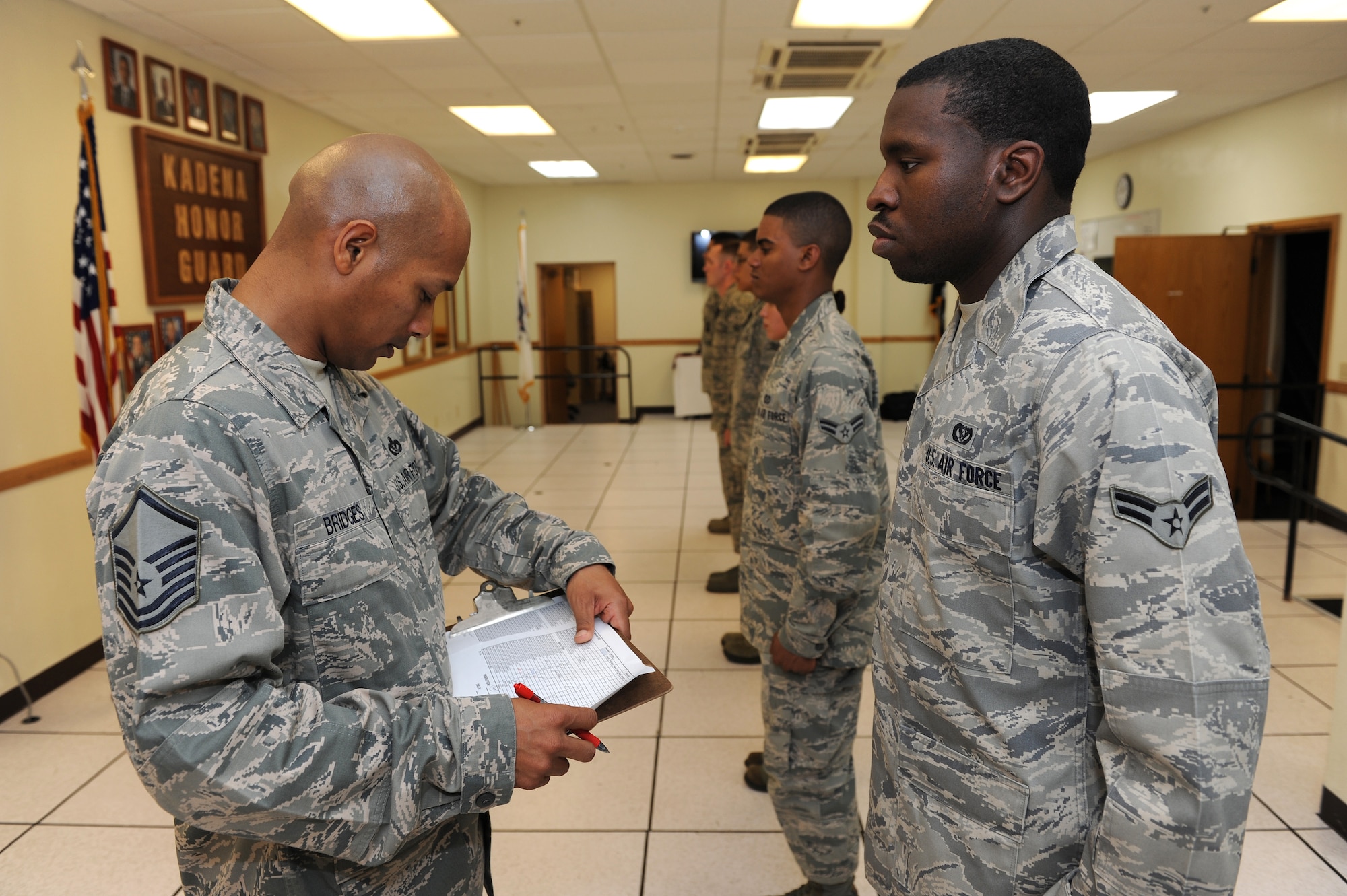 U.S. Air Force Master Sgt. Jerome Bridges, 18th Civil Engineer Squadron superintendent of the Kadena Honor Guard, inspects the uniform of U.S. Air Force Airman 1st Class Devar Greene, 18th Civil Engineer Squadron operations manager, during honor guard practice Apr. 25, on Kadena Air Base, Japan. During the inspection the honor guard members are carefully checked to ensure items such as rings and watches are not on and pockets are empty. (U.S. Air Force photo/Junko Kinjo)
