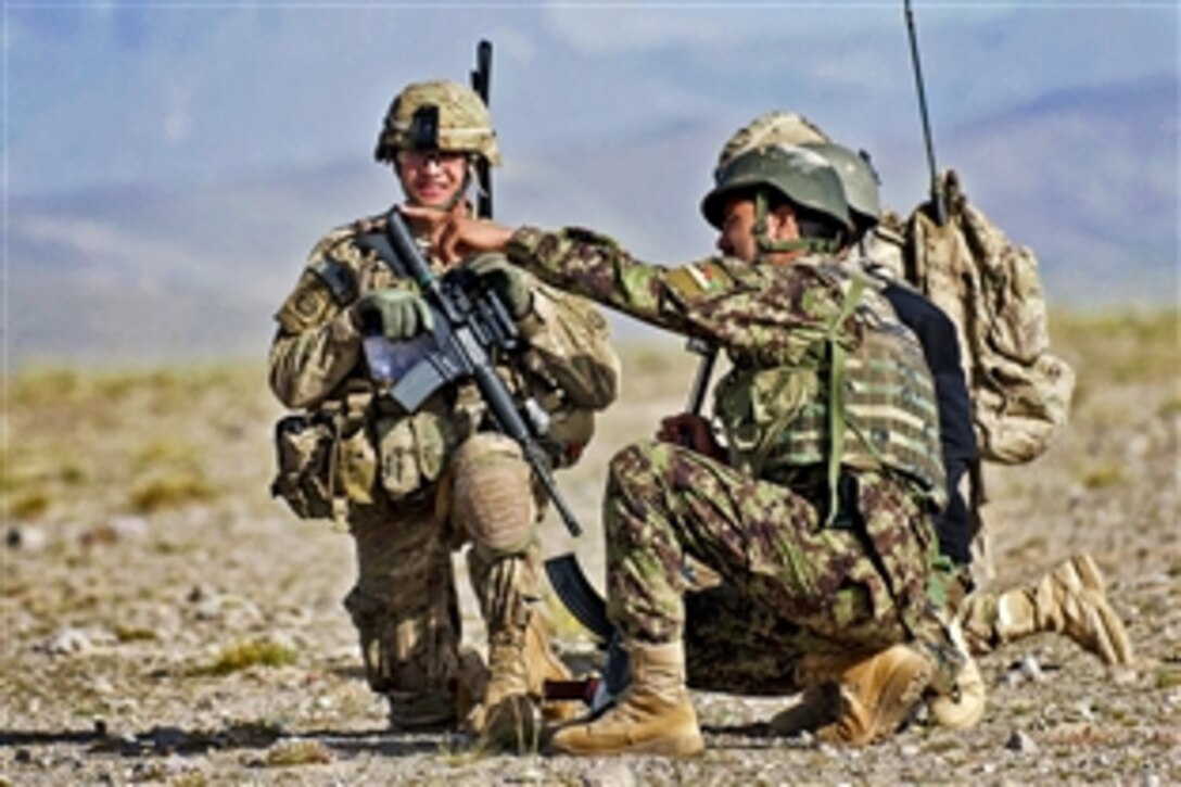 An Afghan company executive officer suggests a route into a village to U.S. Army 1st Lt. Kirk Shoemaker during a patrol in Afghanistan's Ghazni province, May 29, 2012. Shoemaker is a platoon leader assigned to the 2nd Battalion, 504th Parachute Infantry Regiment, 1st Brigade Combat Team, 82nd Airborne Division.