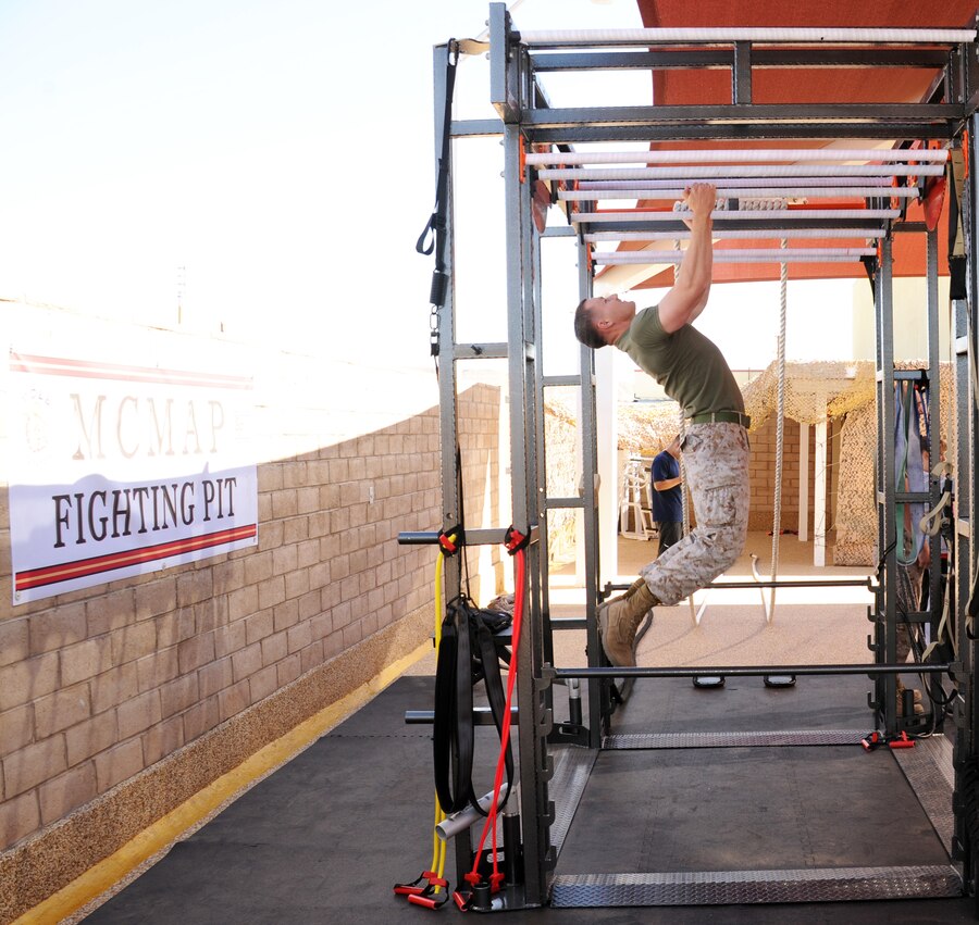 Sergeant Chad Ostrander, communications assets manager, Headquarters Battalion with Marine Corps Logistics Base Barstow, demonstrates one of the many stations of the new martial arts training facility aboard the installation June 6.