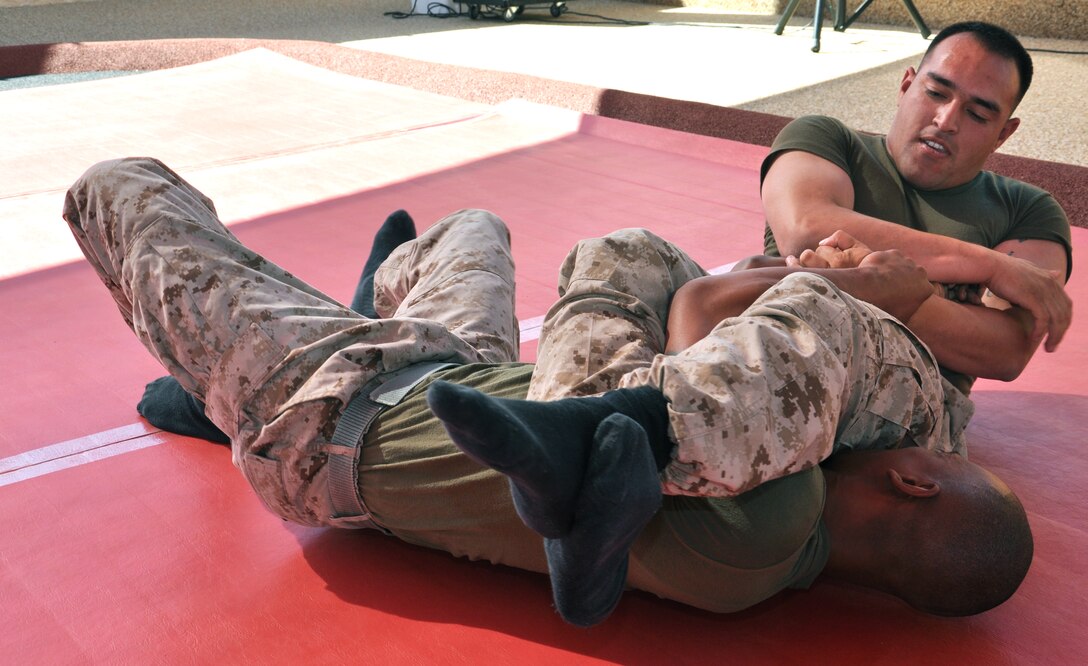 Sgt. Anthony Villalobos, assistant chief for S-3 and S-4 and Cpl. Sir Edward Daniels, an armorer with Headquarters Battalion aboard Marine Corps Logistics Base Barstow, grapple during the grand opening of the new martial arts training facility aboard MCLB Barstow, June 6.