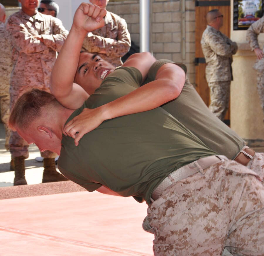 Corporals Van Truong and Christopher Foster, adjutant clerks, Headquarters Battalion with Marine Corps Logistics Base Barstow grapple during the grand opening of the new martial arts training facility aboard the installation June 6.