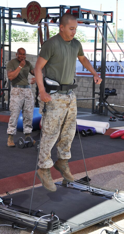 Corporal Miguel Verdin, an automotive diesel mechanic with Fleet Support Division stationed aboard Marine Corps Logistics Base Barstow, tests out a new piece of resistance equipment at the grand opening of the new martial arts training facility aboard the installation June 6.
