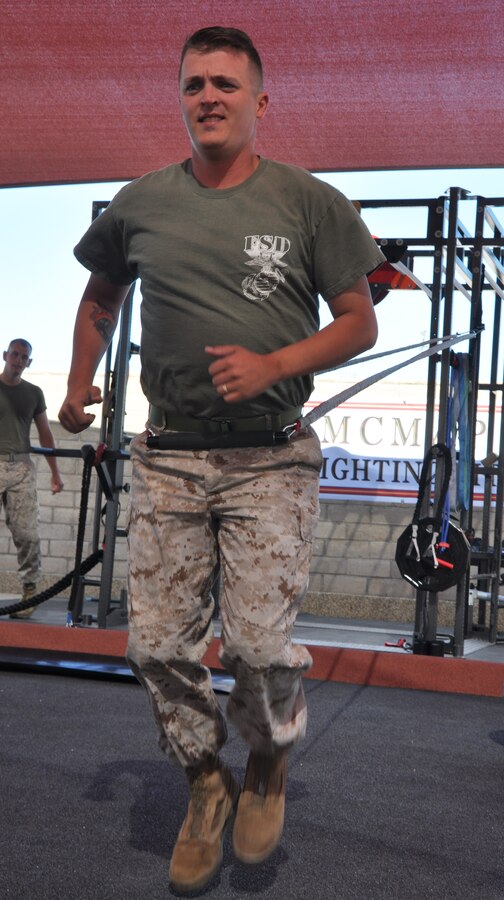 Staff Sgt. Paul Coursey, operations chief for Fleet Support Division stationed aboard Marine Corps Logistics Base Barstow, tests out a new piece of resistance equipment at the grand opening of the new martial arts training facility aboard the installation June 6.