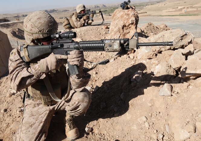 Sgt. Waylon Sliker, ammunition technician, 1st Battalion, 8th Marine Regiment, searches for insurgents during an indirect fire attack at Forward Operating Base Whitehouse April 10, 2012.