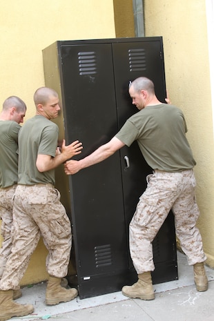 Recruits of Company D, 1st Recruit Training Battalion, work with the Depot Chapel to move furniture during Team Week aboard Marine Corps Recruit Depot San Diego May 23. During Team Week recruits help, on average, 10 different organizations a day.
