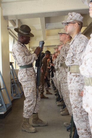 Company K drill instructors inspect their recruits weapons June 1 during Senior Drill Instructor Inspection aboard Marine Corps Recruit Depot San Diego. Recruits were also inspected on their uniforms and Marine Corps knowledge. This inspection gave the senior drill instructors a chance to see which recruits required extra attention.