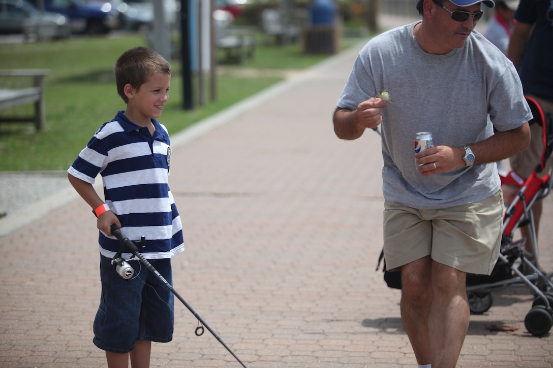 A child watches as his fishing line has bait attached to it during Military Appreciation Day at Morehead City, N.C., June 2. The day was to honor service members and to provide a day of recreation for the whole family. 