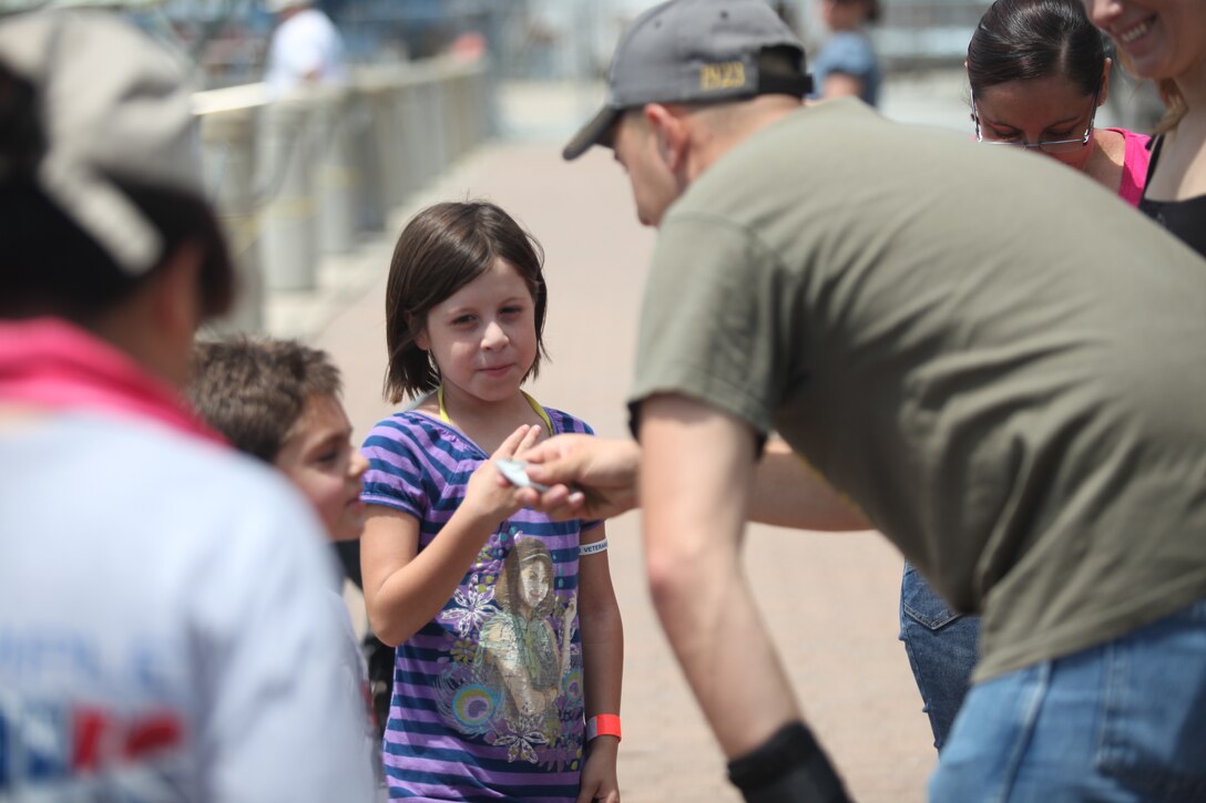 A young boy looks at a fish that he caught while fishing during Military Appreciation Day at Morehead City, N.C., June 2. Fishing was a popular activity during the event by both children and adults. 