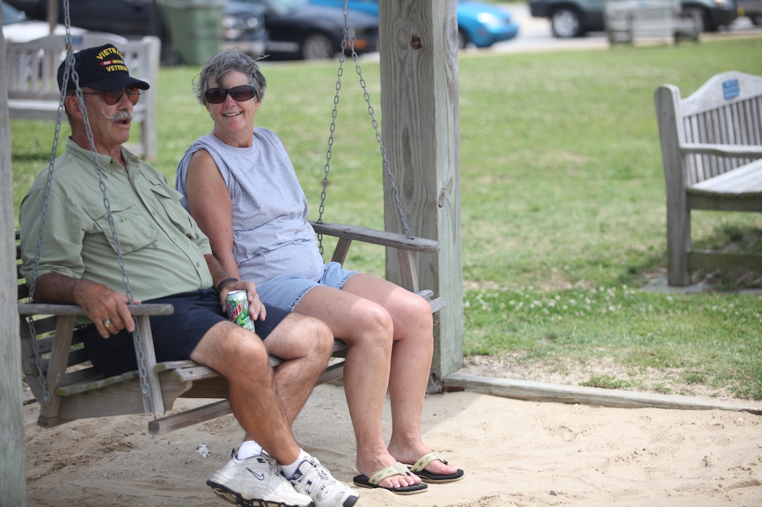 A couple finds a quiet place to sit and enjoy the sun by the water during the Military Appreciation Day at Morehead City, N.C., June 2. Many military veterans were in attendance to enjoy a day of recreation with their families. 