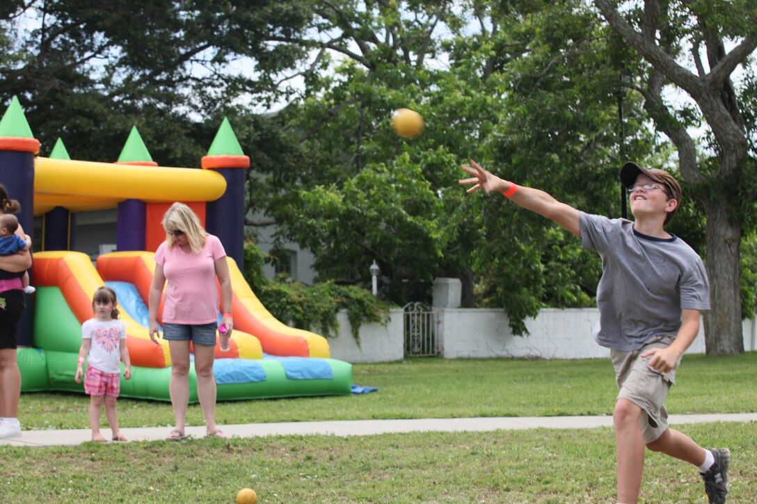 A child throws a ball at a target in the hopes of dunking someone into a tub of water during Military Appreciation Day at Morehead City, N.C., June 2. The event offered many different activities for children to enjoy. 