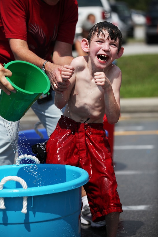 Michael Cooney’s family and teachers worked hard to help him fully engage his new mobility. Once unable to walk, Michael now enjoys the water games and races alongside his peers at Marine Corps Base Camp Lejeune, June 1. 