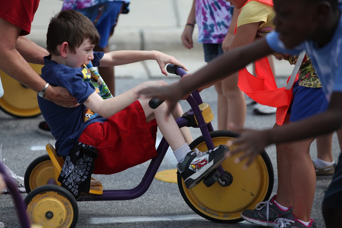 Cerebral palsy kept Michael Cooney from engaging in many of the activities his peers enjoyed every day. Now, with the school year coming to a close for the elementary schools at Marine Corps Base Camp Lejeune, Michael’s new found freedom has allowed him to partake in the races and games that made up the students’ Field Day, June 1.