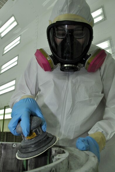 Airman 1st Class Vanessa Sanchez, 60th Maintenance Squadron, demonstrates sanding a C-5 Galaxy hub Monday at the aircraft structural maintenance back shop. The hub would normally be sand blasted, but if the blaster was inoperable, sanding could be required. (U.S. Air Force photo/Staff Sgt. Timothy Boyer)