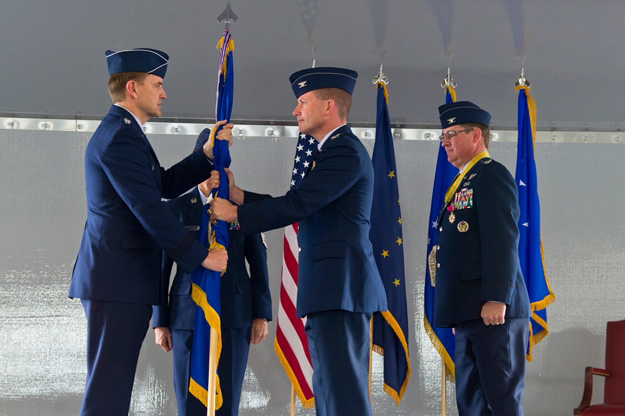 Air Force Col. Brian Duffy assumes command from Lt. Gen. Stephen Hoog, Alaska Command and 11th Air Force commander, of Joint Base Elmendorf-Richardson and the 673d Air Base Wing during a change-of-command ceremony at Hangar 5 on JBER June 1, 2012. Duffy comes from Kadena Air Base where he served as the commander of the 18th Civil Engineer Group. (U.S. Air Force photo/Staff Sgt. Zachary Wolf) 
