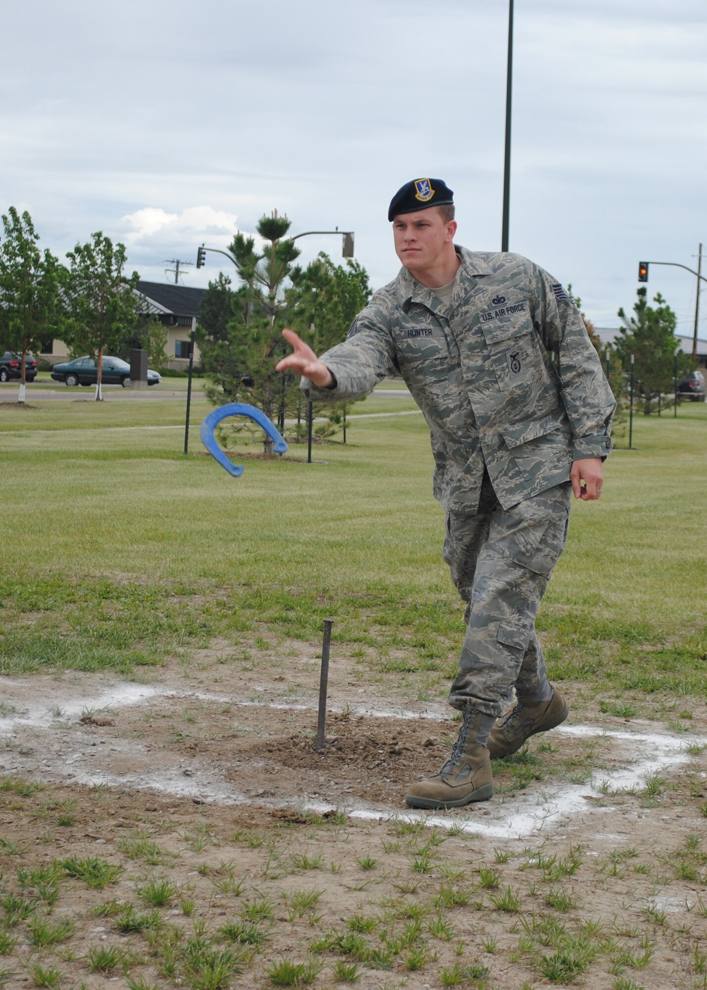 Tech. Sgt. Brandon Hill, 341st Contracting Squadron contract specialist, concentrates on aiming at the stake during a game of horseshoes. (U.S. Air Force photo/Airman 1st Class Katrina Heikkinen)