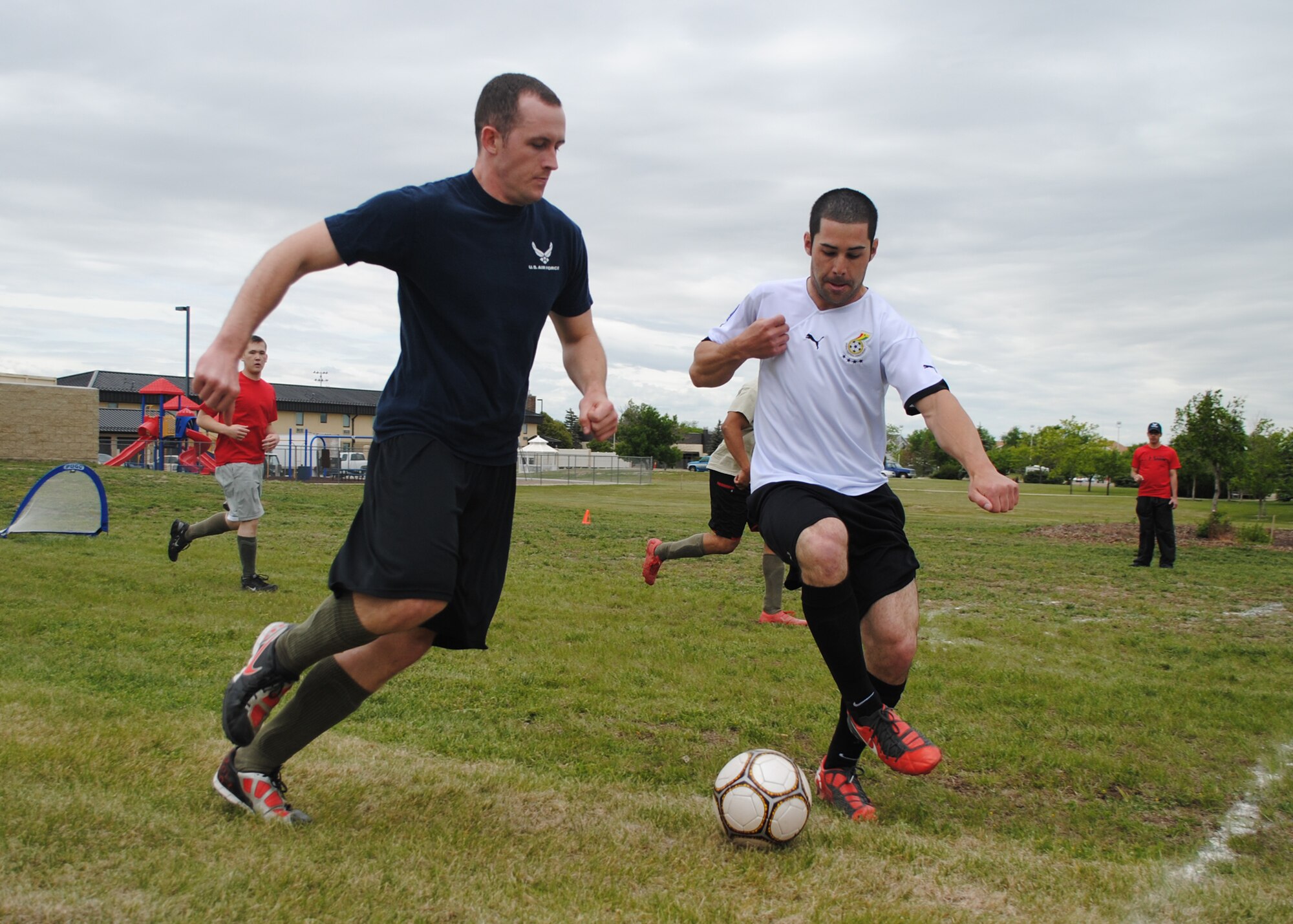Senior Airman Wyatt Stinnett, 341st Medical Operations Squadron dental assistant, tries to steal a soccer ball from Airman 1st Class Jordan Cunningham, 341st Civil Engineer Squadron pavement and construction equipment apprentice, during a three-on-three soccer game during a Wing Sports Smackdown event at the Grizzly Bend on June 1. More than 300 Team Malmstrom members participated in games at the event, including a rowing challenge, football toss, horse shoes and pingpong. The 341st Mission Support Group took home the first place trophy after earning 1,105 points in all the games. (U.S. Air Force photo/Airman 1st Class Katrina Heikkinen)