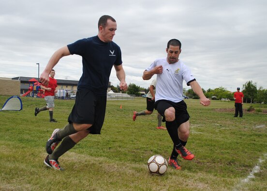 Senior Airman Wyatt Stinnett, 341st Medical Operations Squadron dental assistant, tries to steal a soccer ball from Airman 1st Class Jordan Cunningham, 341st Civil Engineer Squadron pavement and construction equipment apprentice, during a three-on-three soccer game during a Wing Sports Smackdown event at the Grizzly Bend on June 1. More than 300 Team Malmstrom members participated in games at the event, including a rowing challenge, football toss, horse shoes and pingpong. The 341st Mission Support Group took home the first place trophy after earning 1,105 points in all the games. (U.S. Air Force photo/Airman 1st Class Katrina Heikkinen)