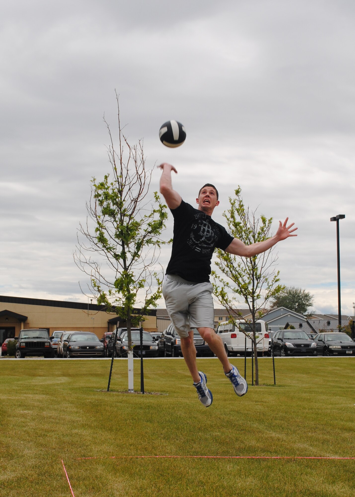 Airman 1st Class Justin Colberg, 341st Logistics Readiness Squadron traffic management apprentice, jumps to spike a ball during a two-on-two volleyball game against the 341st Medical Group. The 341st Medical Group took first place in the volleyball tournament. (U.S. Air Force photo/Airman 1st Class Katrina Heikkinen)