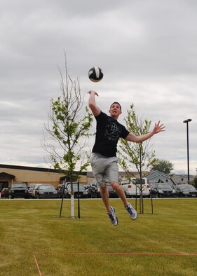 Airman 1st Class Justin Colberg, 341st Logistics Readiness Squadron traffic management apprentice, jumps to spike a ball during a two-on-two volleyball game against the 341st Medical Group. The 341st Medical Group took first place in the volleyball tournament. (U.S. Air Force photo/Airman 1st Class Katrina Heikkinen)