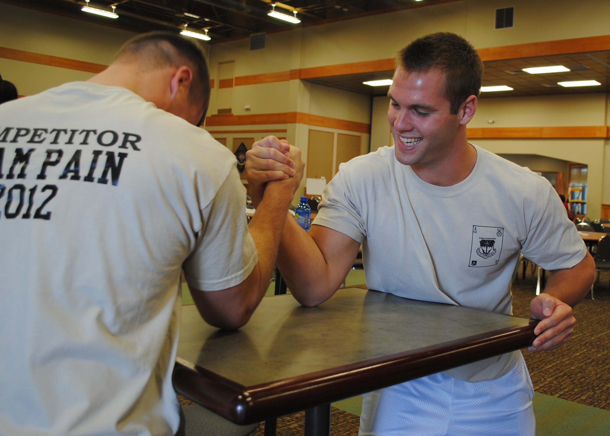 Airman 1st Class Kyle Klusacek, 741st Missile Security Forces Squadron member, left, arm wrestles Airman 1st Class Alex Callahan, 741st MSFS security escort team member, during the Wing Sports Smackdown at the Grizzly Bend on June 1. Both Airman earned five points ot help the 341st Secuirty Forces Group take second place in the event, with a score of 980. (U.S. Air Force photo/Airman 1st Class Cortney Paxton)