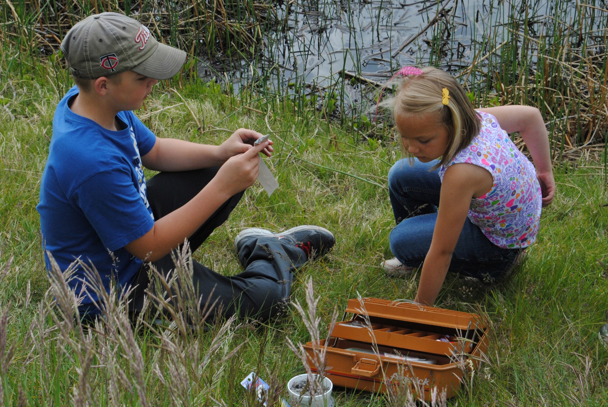 Ian, 11, and his sister Cally, 6, go through some items in their tackle box. They were two of many children who attended National Kid's Fishing Day at Powwow Pond on June 2. (U.S. Air Force photo/Airman 1st Class Cortney Paxton)