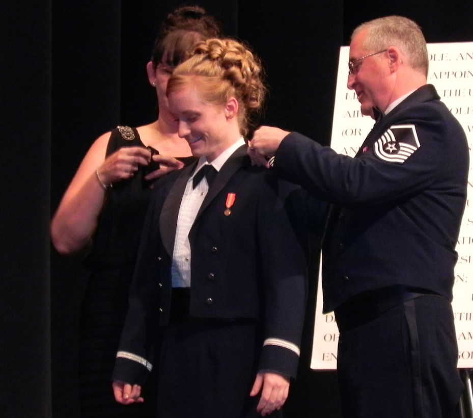 Master Sgt. Jim Clements (right), 446th Aerospace Medicine Squadron optometry NCOIC, out of McChord Field, Wash., pins second lieutenant on his newly commissioned daughter, 2nd. Lt. Monica Clements, during commencement festivities at the Air Force Academy here, May 23, Colorado Springs, Colo. During the June Reserve weekend, Lt. Clements carried out her first duty, which was swearing in her father for his last reenlistment. (Courtesy photo)