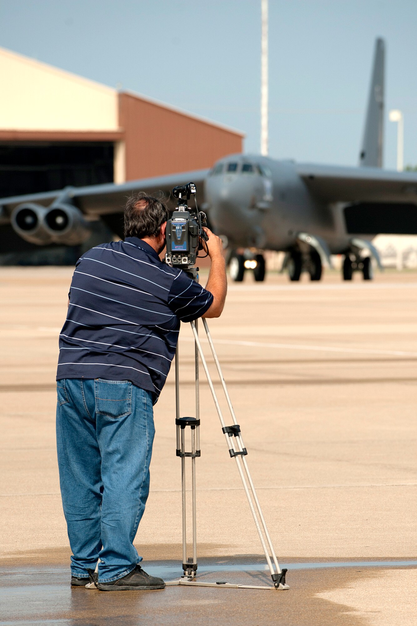 Art Nerio, KTAL News 6 videographer, videos a 93rd Bomb Squadron B-52H Stratofortress as it taxis for a mission on Barksdale Air Force Base, La., June 6, 2012. KTAL features a weekly news segment called the Barksdale Profile, which focuses on personnel and events happening on Barksdale. (U.S. Air Force photo by Master Sgt. Greg Steele/Released)