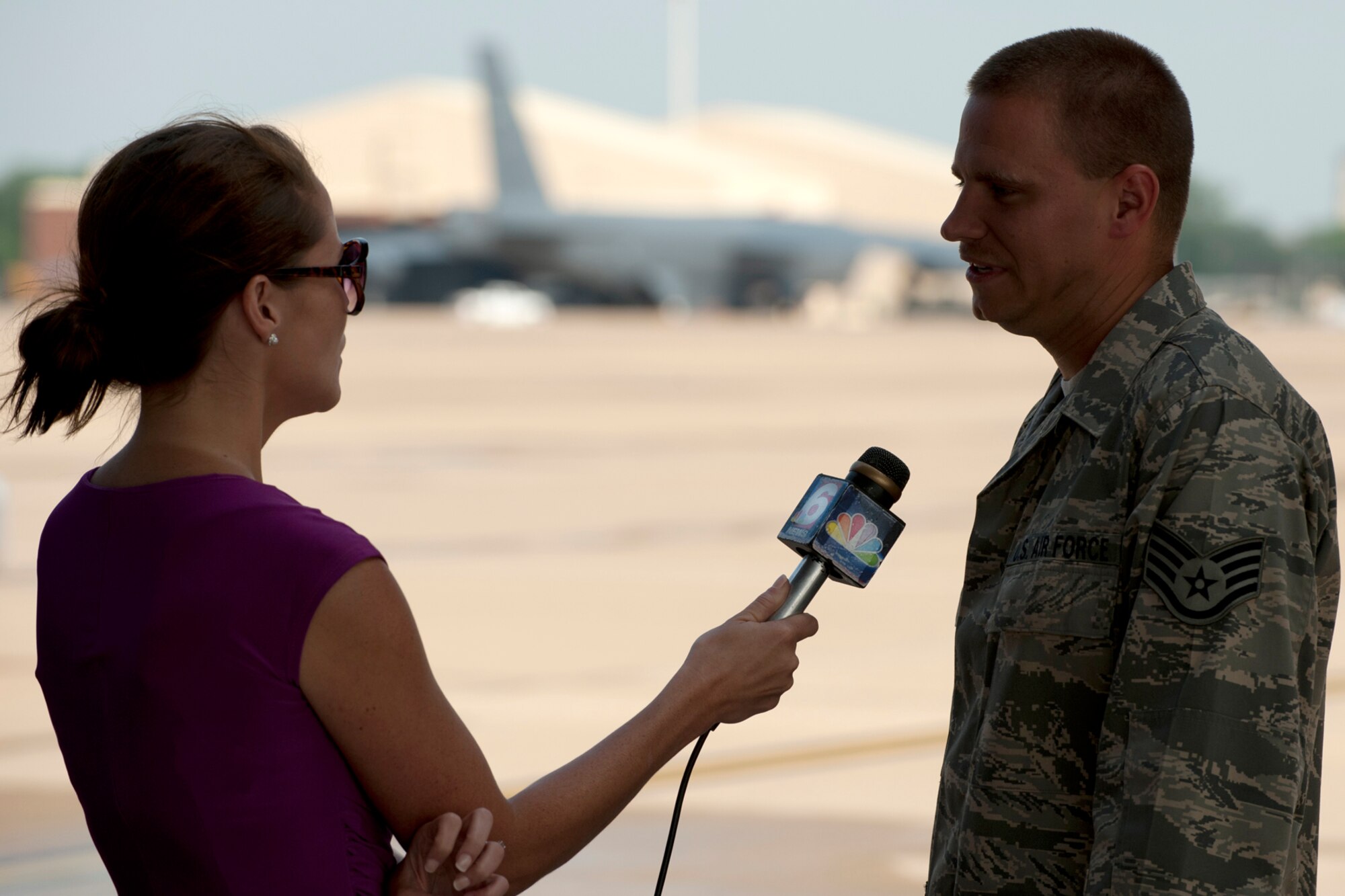 U.S. Air Force Staff Sgt. Stacy Perry, 2nd Aircraft Maintenance Squadron crew chief, is interviewed by Leslie Draffin, KTAL New 6 morning anchor, for a Barksdale Profile news segment, Barksdale Air Force Base, La., June 6, 2012. The Barksdale Profile focuses on personnel and events happening on base, and the subject of this segment is how airmen battle the summer heat on the flight line. (U.S. Air Force photo by Master Sgt. Greg Steele/Released)