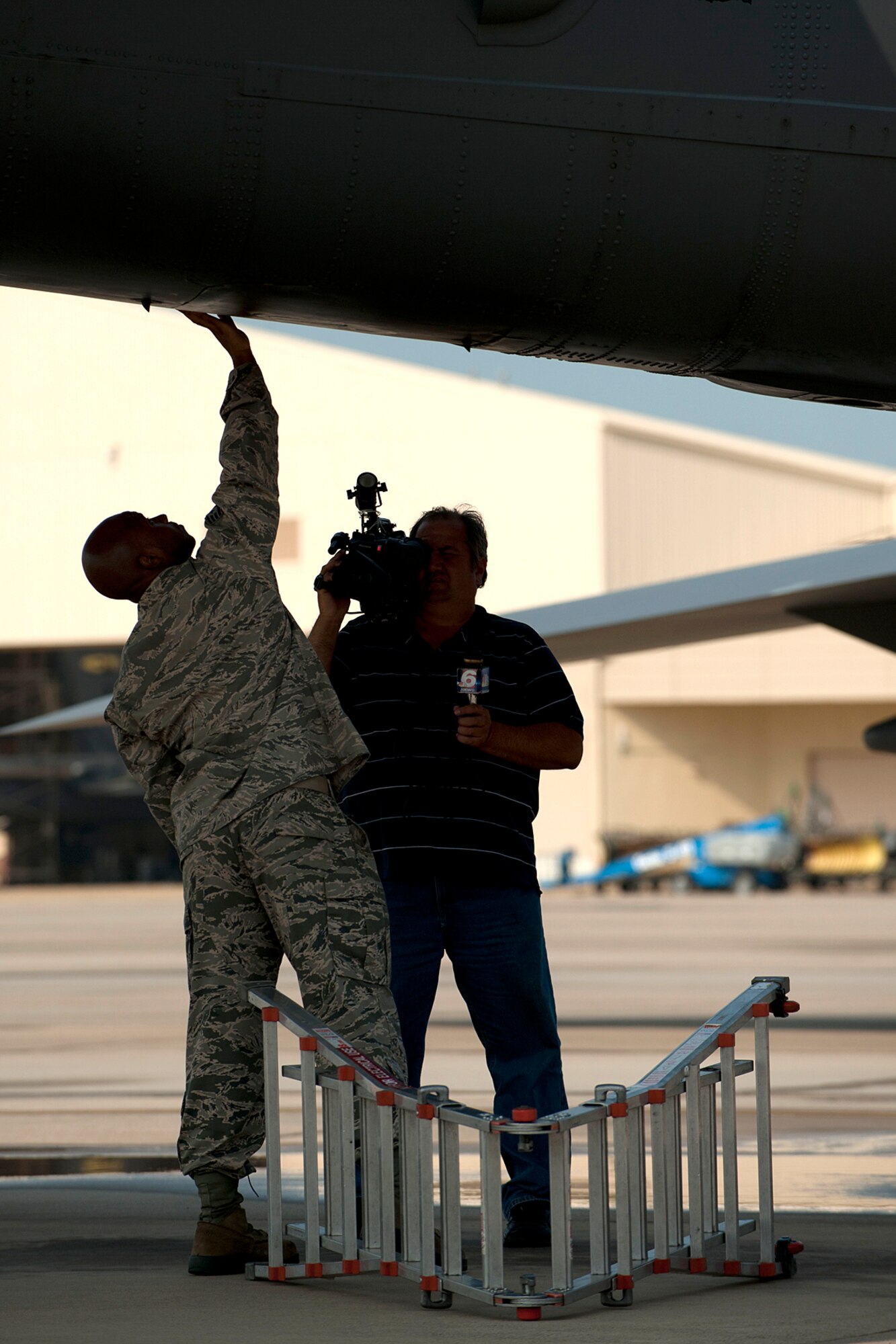 Art Nerio, KTAL News 6 videographer, takes video of U.S. Air Force Staff Sgt. Tahime Green, 2nd Aircraft Maintenance Squadron crew chief, as he performs a preflight inspection on a 93rd Bomb Squadron B-52H Stratofortress, Barksdale Air Force Base, La., June 6, 2012. KTAL hosts a weekly Barksdale Profile news segment featuring personnel and events happening on Barksdale. (U.S. Air Force photo by Master Sgt. Greg Steele/Released)