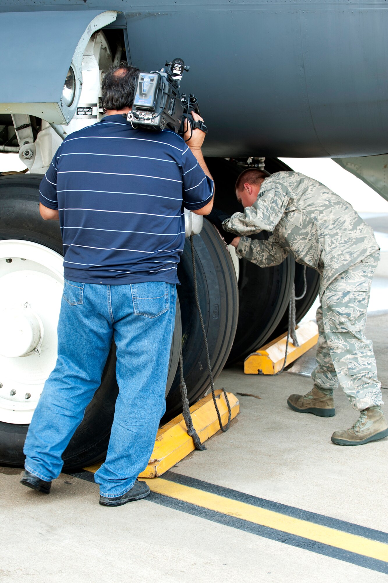 Art Nerio, KTAL News 6 videographer, takes video of U.S. Air Force Staff Sgt. Stacy Perry, 2nd Aircraft Maintenance Squadron crew chief, as he performs a preflight inspection on a 93rd Bomb Squadron B-52H Stratofortress, Barksdale Air Force Base, La., June 6, 2012. KTAL hosts a weekly Barksdale Profile news segment featuring personnel and events happening on Barksdale. (U.S. Air Force photo by Master Sgt. Greg Steele/Released)