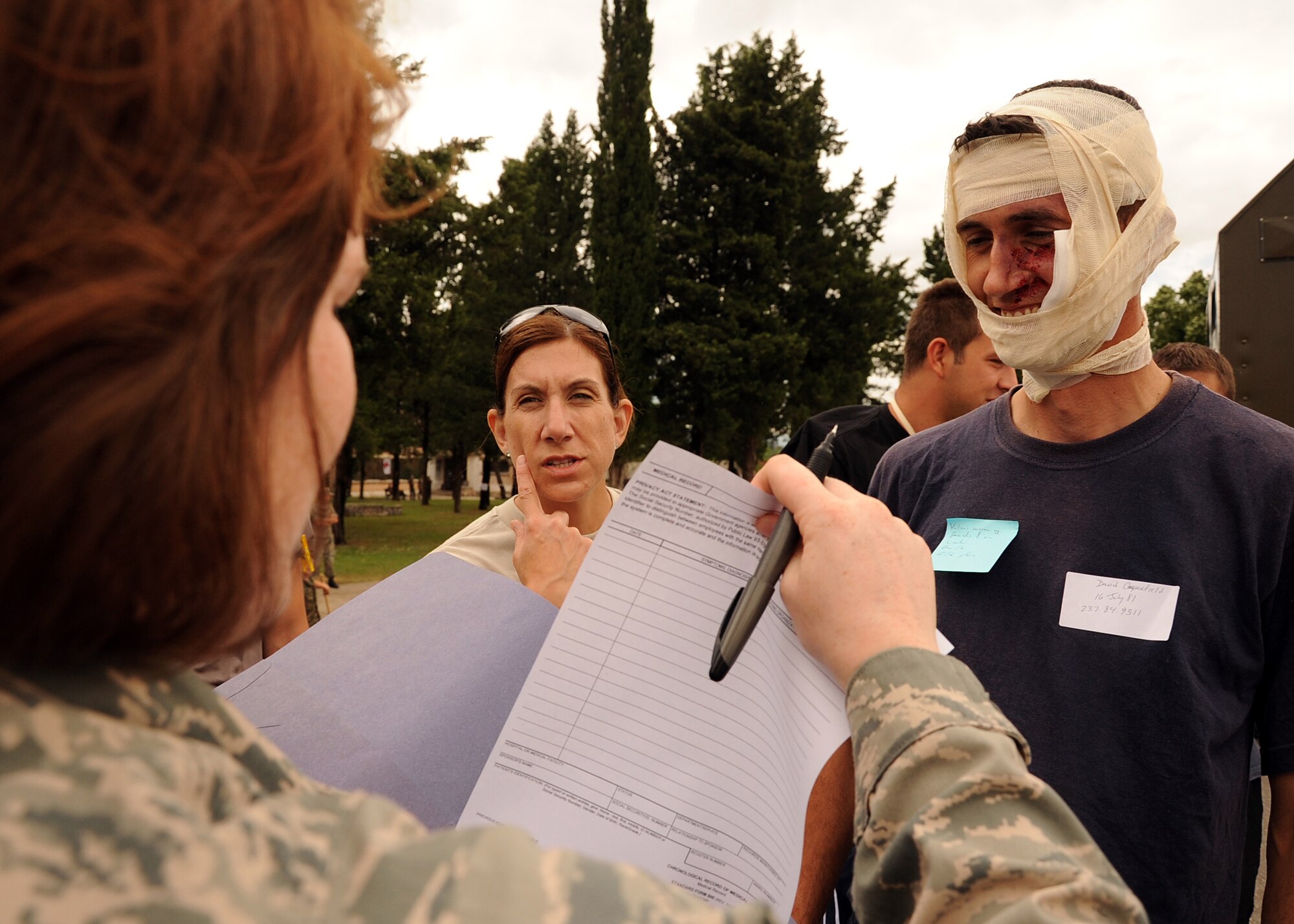 U.S. Air Force Capt. Jill Lemieux, middle, explains an injury to U.S. Air Force Staff Sgt. Grace Smith, during Shared Resilience 2012 at Capljina, Bosnia-Herzegovina, June 5, 2012. More than 500 military members from nine nations are participating in Shared Resilience 2012, an annual U.S. Joint Chiefs of Staff-sponsored exercise, May 28 through June 8. Lemieux is a triage nurse and Smith is a patient tracking technician. (U.S. Air Force photo/Staff Sgt. Daryl Knee)