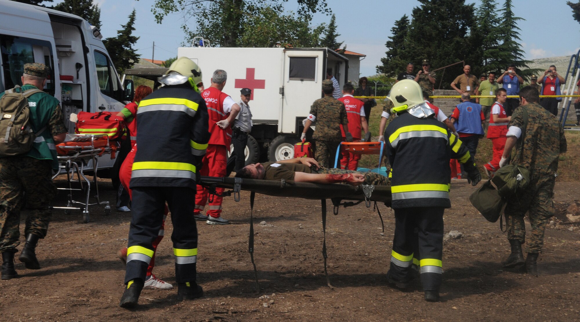 Participants of Shared Resilience 2012 carry a victim to safety during a collapsed building scenario at Capljina, Bosnia-Herzegovina, June 4, 2012. The exercise, in the spirit of partnership for peace, directly supports U.S. European Command's theater cooperation efforts and strategy for active security with European countries. (U.S. Air Force photo/Staff Sgt. Tabitha Lee)