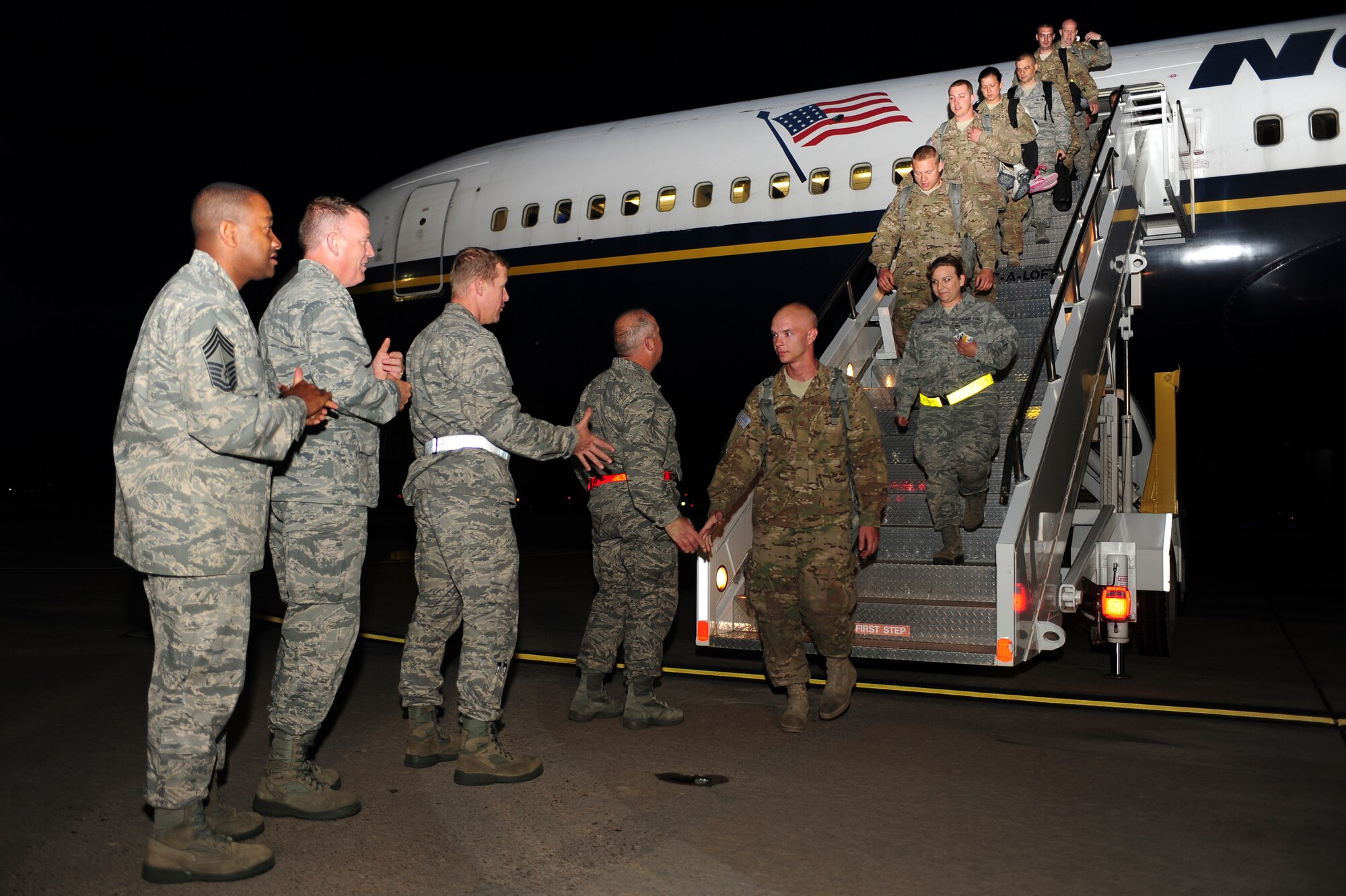 Airmen exit an aircraft and are greeted by 27th Special Operations Wing leadership upon returning from deployment during Operation Homecoming at Cannon Air Force Base, N.M., June 4, 2012. Operation Homecoming is a monthly event held to welcome Air Commandos back from worldwide deployments and reunite them with family and friends. (U.S. Air Force photo by Airman 1st Class Eboni Reece)