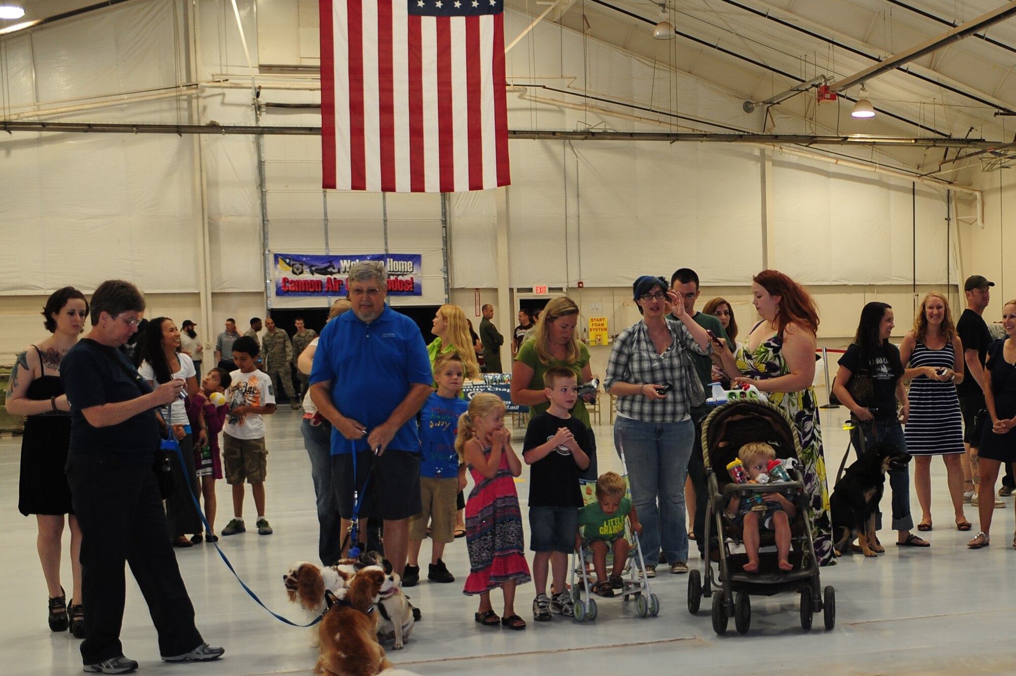 Friends and family of deployed airmen gather together awaiting their arrival during Operation Homecoming at Cannon Air Force Base, N.M., June 4, 2012. Operation Homecoming is a monthly event held to welcome Air Commandos back from worldwide deployments and reunite them with family and friends. (U.S. Air Force photo by Airman 1st Class Eboni Reece)