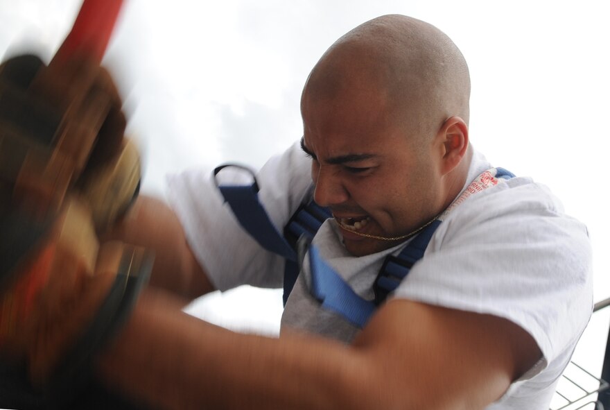 U.S. Air Force Staff Sgt. Skipper Valentin-Cruzado simulates chopping with a shot mallet as he practices for a mid-August firefighter combat challenge on Seymour Johnson Air Force Base, N.C., June 5, 2012. The chopping part of the challenge imitates forcible entry, a common task for firefighters when attempting to enter a burning building. Valentin-Cruzado, 4th Civil Engineer Squadron NCO in charge of logistics, hails from Mayaguez, Puerto Rico. (U.S. Air Force photo/Airman 1st Class Aubrey Robinson/Released)