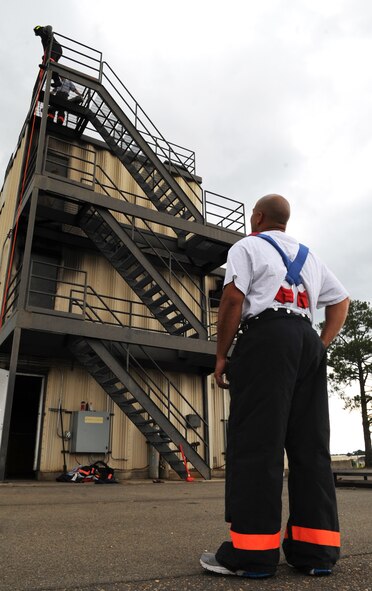U.S. Air Force Staff Sgt. Skipper Valentin-Cruzado watches Marcus Sheppard practice for a firefighter combat challenge at the burn tower on Seymour Johnson Air Force Base, N.C., June 5, 2012. Firefighters from the 4th Civil Engineer Squadron will compete against several other fire stations in August. Valentin-Cruzado, 4th CES NCO in charge of logistics, hails from Mayaguez, Puerto Rico. Sheppard, 4th CES lead firefighter, is a native of Goldsboro, N.C. (U.S. Air Force photo/Airman 1st Class Aubrey Robinson/Released)