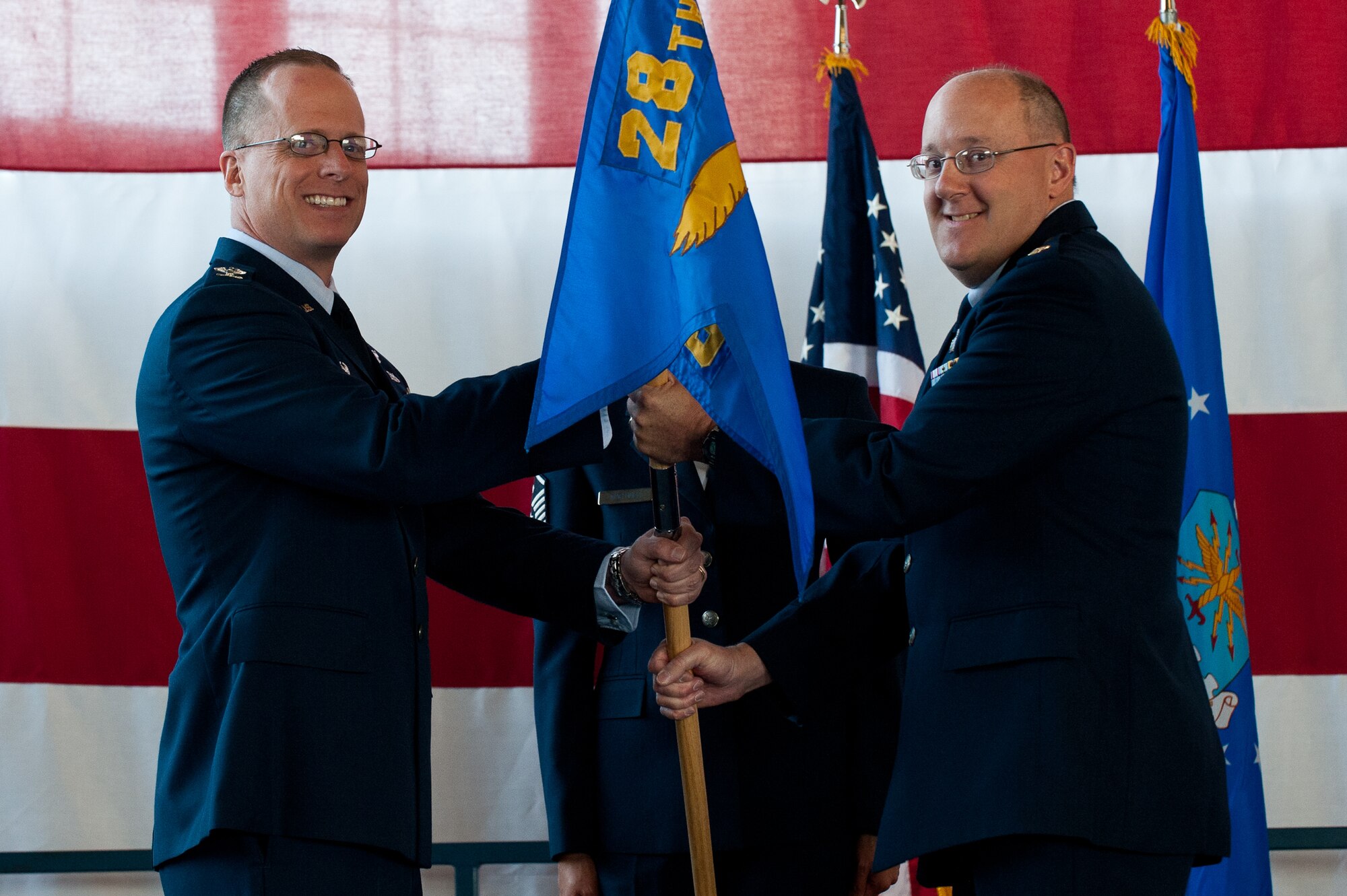 Maj. Garry Elliott (right) accepts command of the 28th Comptroller Squadron from Col. Mark Weatherington, 28th Bomb Wing commander, during a change of command ceremony on Ellsworth Air Force Base, S.D., June 4, 2012. As the 28th CPTS commander, Elliott will be in command of the base’s numerous comptrollers as well as administratively in command of all Airmen assigned as to the 28th BW staff. (U.S. Air Force photo by Airman 1st Class Kate Thornton/Released)