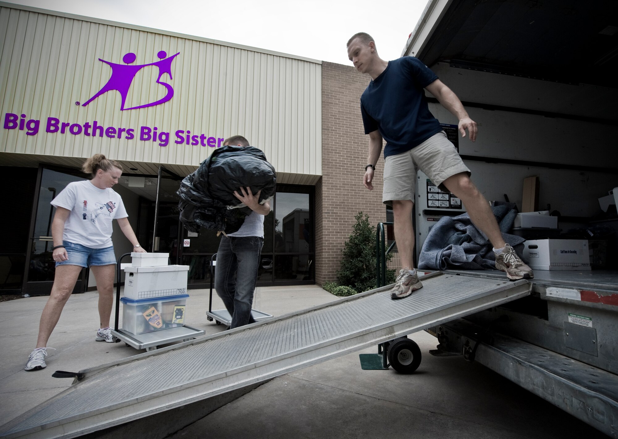 Volunteers from the 317th Operations Support Squadron in Dyess Air Force Base, Texas, move Big Brothers Big Sisters’ supplies into their new location June 6, 2012, in Abilene, Texas. The BBBS program will be relocated to the old First State Bank on 547 Chestnut Street where they are expected to support more than 900 mentoring relationships. For more information, call (325) 676-2227. (U.S. Air Force photo by Airman 1st Class Jonathan Stefanko/ Released)