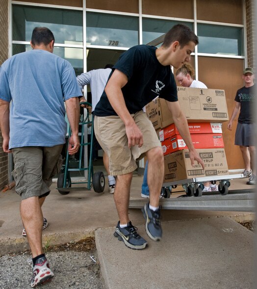 Volunteers from the 317th Operations Support Squadron, Dyess Air Force Base, Texas, move Big Brothers Big Sisters’ supplies onto a truck June 6, 2012, in Abilene, Texas. The BBBS program will be relocated to the old First State Bank on 547 Chestnut Street where they are expected to support more than 900 mentoring relationships. For more information, call (325) 676-2227. (U.S. Air Force photo by Airman 1st Class Jonathan Stefanko/ Released)