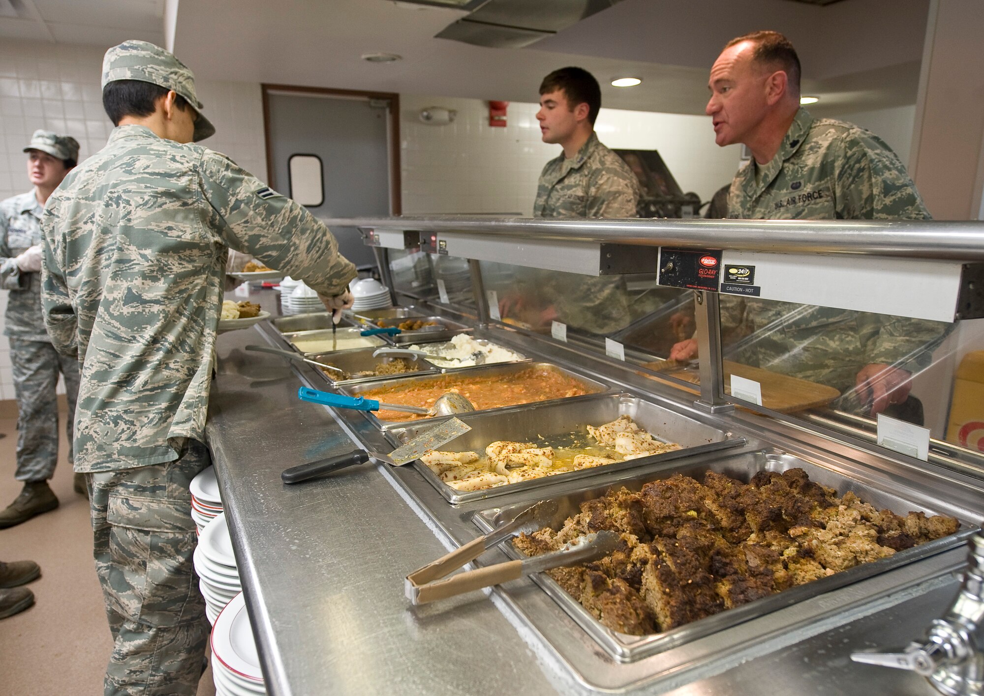 Airman 1st Class Christian Noe, 2nd Force support Squadron, serves lunch in the Red River Dining Facility on Barksdale Air Force Base, La., June 6. The dining facility offers a wide variety of food, including several healthy options for patrons to choose from. (U.S. Air Force photo/Staff Sgt. Chad Warren)(RELEASED)