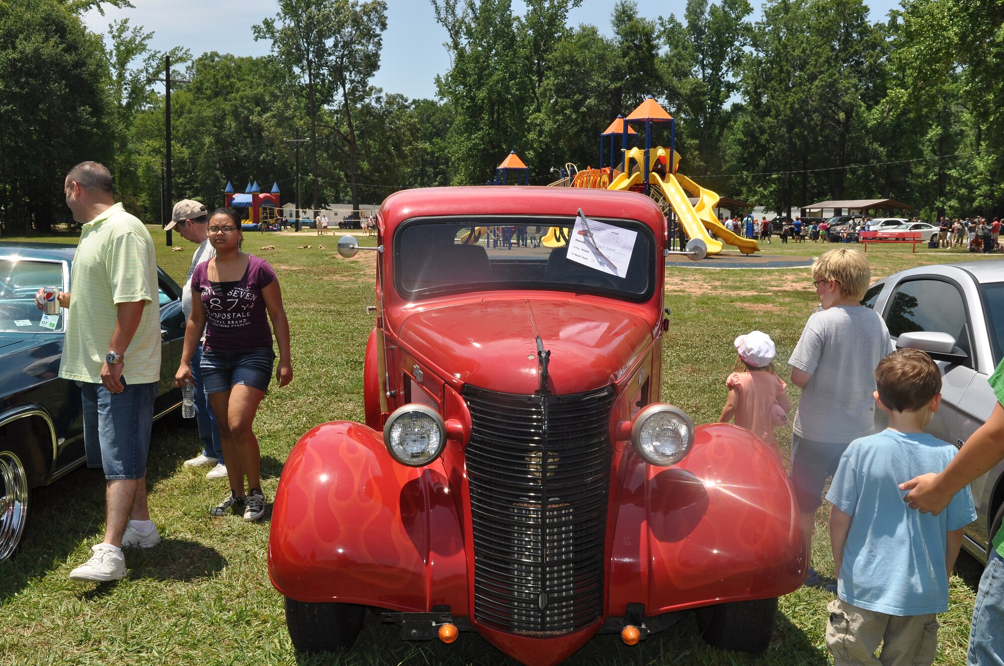 Some attendees at the 307th Bomb Wing/917th Fighter Group Family Day make their way through the entries into the car show at Cullen Park on Barksdale Air Force Base, La., June 2, 2012. The annual event is an opportunity for the Reservists and their families to get together for some fun and camaraderie. (U.S. Air Force photo/Betty Stephens)